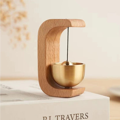 Wireless door chime with brass bell and wood frame